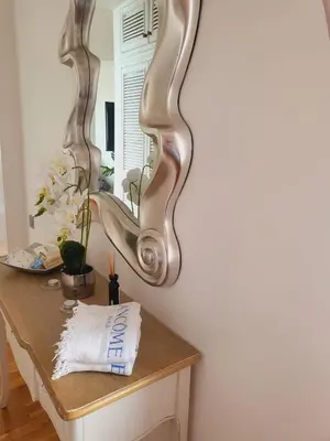 a mirror on a wall next to a table at HOME Funchal Personal 2 in Funchal