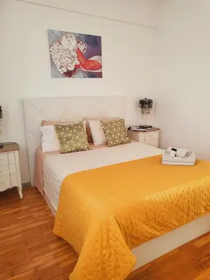 a bedroom with a bed with an orange blanket at HOME Funchal Personal 2 in Funchal