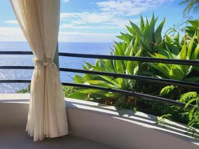 a balcony with a window with a view of the ocean at HOME Funchal Personal 2 in Funchal