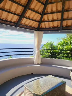 a balcony with a table and a view of the ocean at HOME Funchal Personal 2 in Funchal