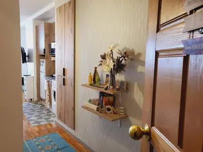 a hallway with a door with a vase of flowers on the wall at HOME Funchal Personal 2 in Funchal
