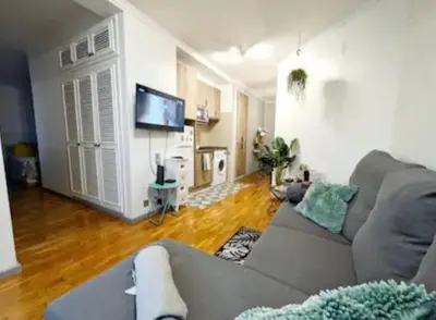 a living room with a couch and a television at HOME Funchal Personal 2 in Funchal