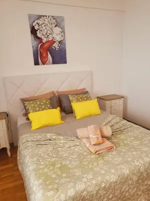 a bedroom with a large bed with yellow pillows at HOME Funchal Personal 2 in Funchal
