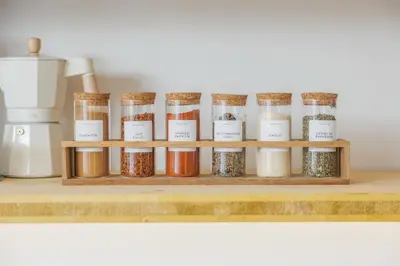 a shelf with jars of spices next to a blender at Ocean Apartment by ENDLESS SUN I modern comfort, sea view, wi-fi, parking, heating in Lagos