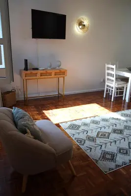 a living room with a couch and a table with a television at The Empress Atlantic Stay Free Parking in Funchal