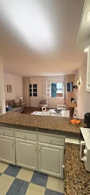 a kitchen with a counter top and a living room at The Empress Atlantic Stay Free Parking in Funchal