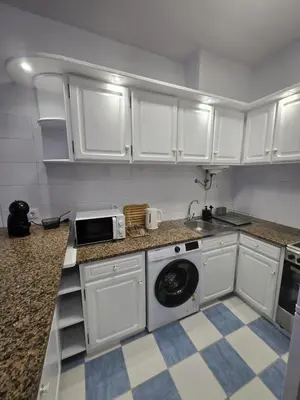 a kitchen with white cabinets and a washing machine at The Empress Atlantic Stay Free Parking in Funchal