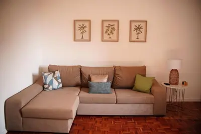 a brown couch in a living room with pillows on it at The Empress Atlantic Stay Free Parking in Funchal
