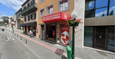 a building with a sign on the side of a street at The Empress Atlantic Stay Free Parking in Funchal
