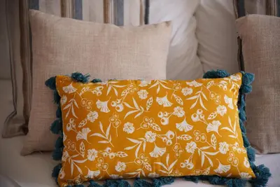 an orange pillow sitting on top of a couch at The Empress Atlantic Stay Free Parking in Funchal