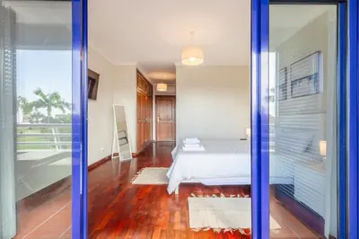 a bedroom with a bed and a sliding glass door at Suite Vista Mar in Funchal