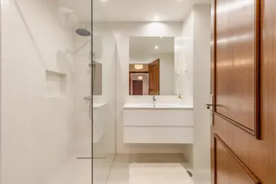 a bathroom with a glass shower and a sink at Suite Vista Mar in Funchal