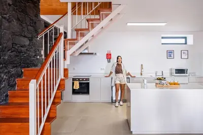 a woman standing in the kitchen of a house at Villa Rosa Mare by Homie in Seixal