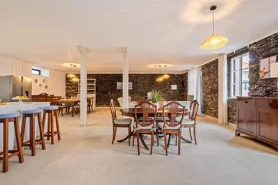 a kitchen and dining room with a table and chairs at Villa Rosa Mare by Homie in Seixal