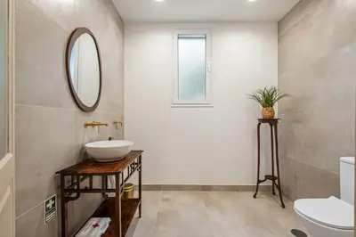 a bathroom with a sink and a mirror at Villa Rosa Mare by Homie in Seixal