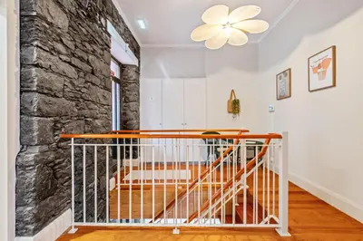 a staircase in a home with a stone wall at Villa Rosa Mare by Homie in Seixal