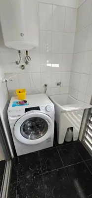 a washing machine in a bathroom with a sink at Harbour View Apartment Free Parking in Funchal