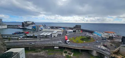a bridge over a road next to the ocean at Harbour View Apartment Free Parking in Funchal