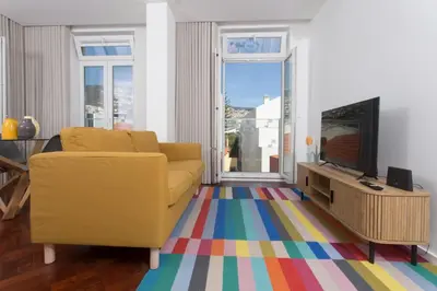 a living room with a couch and a glass table at BJ Apartments Funchal in Funchal