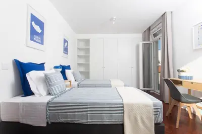 a kitchen with white cabinets and a white refrigerator at BJ Apartments Funchal in Funchal