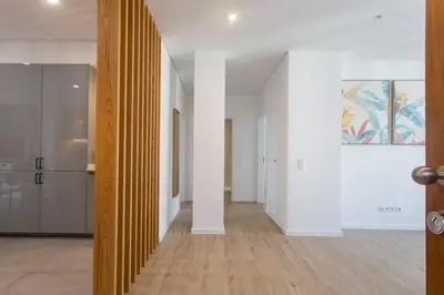 a hallway of a house with white walls and wood floors at BJ Apartments Funchal in Funchal