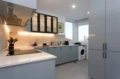 a kitchen with a table with a bowl of fruit on it at BJ Apartments Funchal in Funchal
