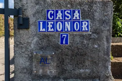 a sign on the side of a stone wall at Casa Leonor by Rent2U, Lda in Arco da Calheta