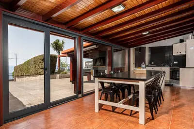 a dining room with a table and some chairs at Casa Leonor by Rent2U, Lda in Arco da Calheta