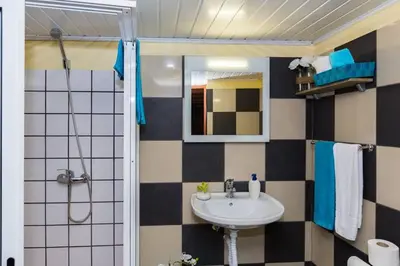 a bathroom with a sink and a mirror at Casa Leonor by Rent2U, Lda in Arco da Calheta