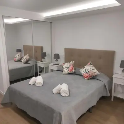 a bedroom with a bed with white pillows on it at Paradise Point Sea & Mountain view in Estreito da Calheta