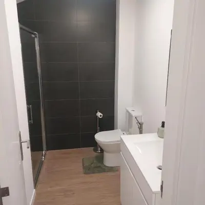 a bathroom with a toilet and a sink and a shower at Paradise Point Sea & Mountain view in Estreito da Calheta