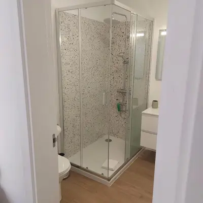 a glass shower in a bathroom with a toilet at Paradise Point Sea & Mountain view in Estreito da Calheta