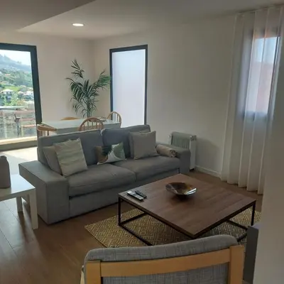 a living room with a couch and a table at Paradise Point Sea & Mountain view in Estreito da Calheta