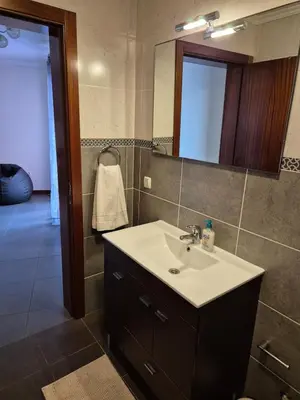 a bathroom with a sink and a mirror at North Coast View in Seixal