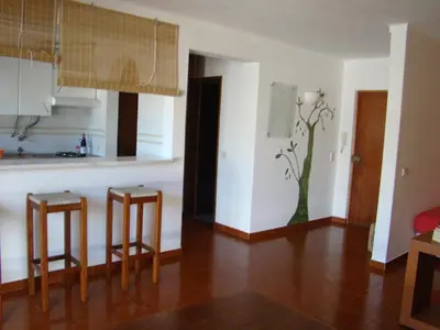 a kitchen with two bar stools in a room at Beach front apartment 1 in Sagres