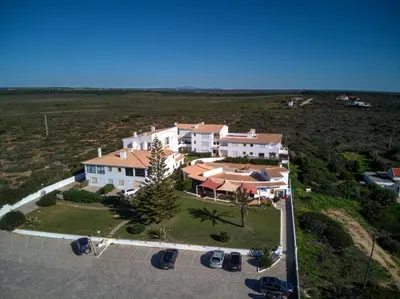 an aerial view of a large house with a yard at Beach front apartment 1 in Sagres