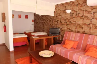 a living room with a couch and a table at Beach front apartment 1 in Sagres