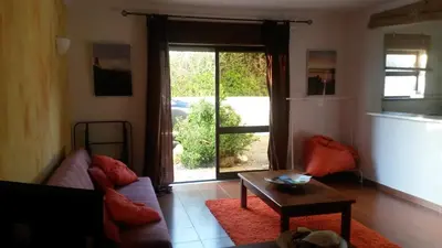 a living room with a couch and a table at Beach front apartment 1 in Sagres