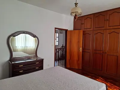 a bedroom with a bed and a mirror and a dresser at Casa Figo- Calheta in Calheta