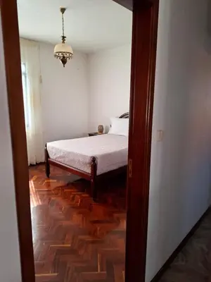 a bedroom with a bed and a room with a mirror at Casa Figo- Calheta in Calheta