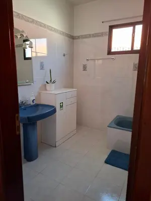 a bathroom with a blue sink and a tub at Casa Figo- Calheta in Calheta
