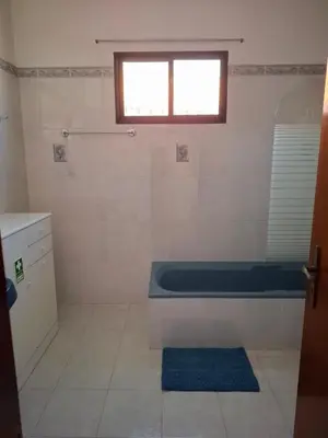 a bathroom with a bath tub and a window at Casa Figo- Calheta in Calheta