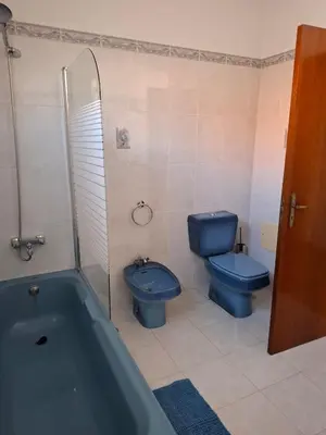 a bathroom with a blue toilet and a blue tub at Casa Figo- Calheta in Calheta