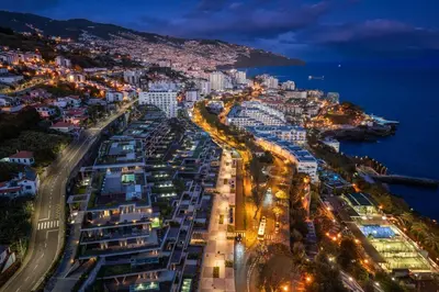 an aerial view of a city at night at Savoy Monumentalis IX by An Island Apart in Funchal