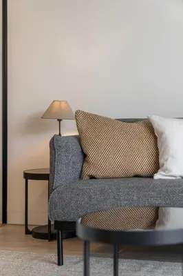 a living room with a couch and a lamp at Savoy Monumentalis IX by An Island Apart in Funchal
