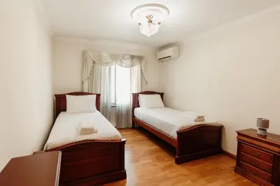 two beds in a small room with a window at Home By SG in Funchal