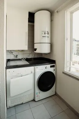 a kitchen with a washing machine and a microwave at Home By SG in Funchal