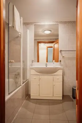 a bathroom with a white sink and a shower at Home By SG in Funchal