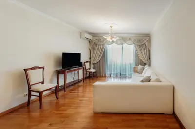a living room with a white couch and a television at Home By SG in Funchal