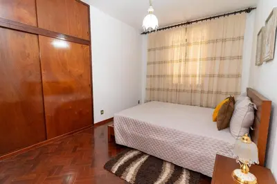 a bedroom with a bed and a large closet at Vista al Mar in Ribeira Brava